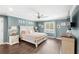 Bright bedroom boasts an accent wall with 'Mr & Mrs' decor over a stylish bed, creating a cozy retreat at 25537 High Hampton Cir, Sorrento, FL 32776