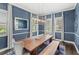 Stunning dining room featuring a wooden table, modern chandelier, wainscoting and plenty of natural light at 25537 High Hampton Cir, Sorrento, FL 32776