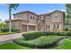 Stunning two-story home with well-manicured landscaping and three-car garage at 25537 High Hampton Cir, Sorrento, FL 32776