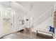 Bright foyer with staircase and stylish entry table at 25537 High Hampton Cir, Sorrento, FL 32776