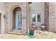 Charming front entrance with stone accents and outdoor seating at 25537 High Hampton Cir, Sorrento, FL 32776