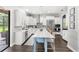 Spacious kitchen featuring white cabinets, stainless appliances, an island with bar seating, and backyard access at 25537 High Hampton Cir, Sorrento, FL 32776