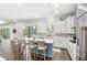 Bright and airy kitchen with a large island, white cabinetry, modern lighting, and backyard pool access at 25537 High Hampton Cir, Sorrento, FL 32776