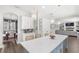 Bright kitchen with a large island, stylish pendant lighting, stainless appliances, and access to the dining room at 25537 High Hampton Cir, Sorrento, FL 32776