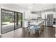 Modern kitchen with white cabinets, large island with seating, stainless steel appliances, and outdoor pool view at 25537 High Hampton Cir, Sorrento, FL 32776