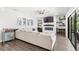 Comfortable living room with a large sectional sofa, modern fireplace, and stylish decor and backyard access at 25537 High Hampton Cir, Sorrento, FL 32776