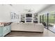Inviting living room with a modern fireplace, large sectional, and sliding glass doors to the outdoor living space at 25537 High Hampton Cir, Sorrento, FL 32776