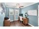 Well-lit home office with a wood desk, task lighting, and neutral walls providing an ideal work environment at 25537 High Hampton Cir, Sorrento, FL 32776