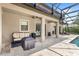 Inviting patio area with outdoor furniture, covered seating, and view of the screened pool at 25537 High Hampton Cir, Sorrento, FL 32776
