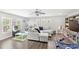 Spacious playroom with hardwood floors, sectional sofa, built-in shelving, and ample space for games at 25537 High Hampton Cir, Sorrento, FL 32776