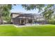 View of a screened-in backyard pool with patio furniture and an attached two-story house at 25537 High Hampton Cir, Sorrento, FL 32776