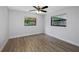Bedroom featuring wood-look floors, two windows, and a ceiling fan at 2804 Clearfield Ave, Orlando, FL 32808