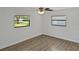 Bedroom with vinyl flooring, a ceiling fan and two windows at 2804 Clearfield Ave, Orlando, FL 32808