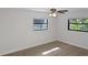 Well-lit bedroom featuring wood-look floors, two windows and a ceiling fan at 2804 Clearfield Ave, Orlando, FL 32808