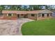 Charming single story home with a circular driveway and well-manicured lawn at 2804 Clearfield Ave, Orlando, FL 32808