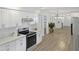Modern kitchen featuring stainless steel appliances, white cabinetry, and quartz countertops at 2804 Clearfield Ave, Orlando, FL 32808