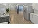 Bright kitchen boasting stainless steel appliances, white cabinets, and wood-look flooring at 2804 Clearfield Ave, Orlando, FL 32808