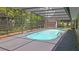 An inviting screened-in pool with light blue water awaits in the backyard at 2804 Clearfield Ave, Orlando, FL 32808