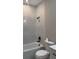 Modern bathroom with marble tile, a bathtub with a shower, and a new toilet and vanity at 317 Mandrake St, Orlando, FL 32811