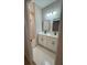 Modern bathroom with double sinks, sleek lighting, and a glass-enclosed tiled shower at 317 Mandrake St, Orlando, FL 32811