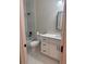 Bright bathroom with white vanity, black fixtures, and marble tile shower at 317 Mandrake St, Orlando, FL 32811