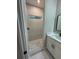 Modern bathroom with marble tile, a stand-up shower with pebble floor, and a new vanity at 317 Mandrake St, Orlando, FL 32811