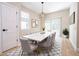 Bright dining room with a large marble table, stylish chairs, modern chandelier, and sliding glass doors at 317 Mandrake St, Orlando, FL 32811