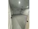 Clean and spacious garage featuring smooth concrete floors, white-painted walls, and an automated door system at 317 Mandrake St, Orlando, FL 32811