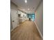 Contemporary kitchen with white cabinets, marble countertops, stainless steel appliances, and open-concept design at 317 Mandrake St, Orlando, FL 32811