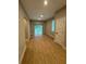 Neutral living room with wood floors, sliding glass doors to the outside, and a large window at 317 Mandrake St, Orlando, FL 32811