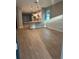 Open living space with modern floors flowing into a white kitchen and dining area at 317 Mandrake St, Orlando, FL 32811