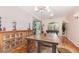 Dining room with chandelier, wooden table, and a decorative cabinet, perfect for Gathering gatherings at 32125 Wekiva Pines Blvd, Sorrento, FL 32776