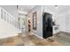 Hallway with tiled floors leading to a kitchen and living space with stairs on the left at 32125 Wekiva Pines Blvd, Sorrento, FL 32776