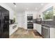 Modern kitchen featuring stainless steel appliances, granite countertops, and mosaic tile backsplash at 32125 Wekiva Pines Blvd, Sorrento, FL 32776