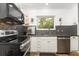 Kitchen featuring stainless steel appliances, granite countertops, and mosaic tile backsplash, and view to the outside at 32125 Wekiva Pines Blvd, Sorrento, FL 32776