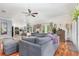 Comfortable living room featuring hardwood floors, French doors, and a grey sectional sofa at 32125 Wekiva Pines Blvd, Sorrento, FL 32776