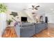 Spacious living room with a large grey sectional sofa, hardwood floors, and a flat screen TV at 32125 Wekiva Pines Blvd, Sorrento, FL 32776