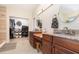 Bathroom featuring dual vanities, granite countertop, walk in closet and tile flooring at 32125 Wekiva Pines Blvd, Sorrento, FL 32776