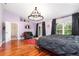 Bright bedroom with wood flooring, chandelier, and doors leading to the outside at 32125 Wekiva Pines Blvd, Sorrento, FL 32776