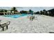Community pool featuring lounge chairs, tables, and umbrellas at 341 Switchgrass Loop, Minneola, FL 34715