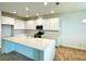 Bright, modern kitchen with a large island, stainless steel appliances, and white cabinetry at 341 Switchgrass Loop, Minneola, FL 34715