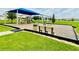 Community playground featuring a slide and swings on a lush green lawn at 341 Switchgrass Loop, Minneola, FL 34715