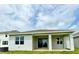 Covered back patio with sliding glass doors and views of the spacious backyard at 341 Switchgrass Loop, Minneola, FL 34715