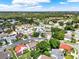 Expansive aerial view of a residential neighborhood showcasing mature trees and well-maintained homes at 3561 Ventura Club Cir, Orlando, FL 32822