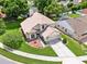 Stunning aerial view of the property showcasing its well-manicured lawn, landscaping, and curb appeal at 3561 Ventura Club Cir, Orlando, FL 32822