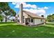 Well-maintained backyard with lush green grass and a covered patio, perfect for outdoor living at 3561 Ventura Club Cir, Orlando, FL 32822