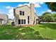 Landscaped backyard featuring a well-manicured lawn and mature trees providing shade and privacy at 3561 Ventura Club Cir, Orlando, FL 32822
