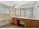Bathroom featuring double sinks, a bathtub, and a large mirror at 3561 Ventura Club Cir, Orlando, FL 32822