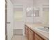 Bathroom featuring vanity with a sink, a large mirror, and a view into the open doorway at 3561 Ventura Club Cir, Orlando, FL 32822