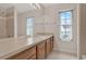 Bathroom featuring double sinks, a large mirror, vanity with cabinets, and natural light from the windows at 3561 Ventura Club Cir, Orlando, FL 32822